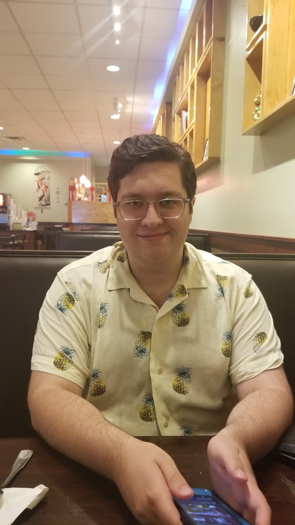 David in a pineapple-print shirt at dinner