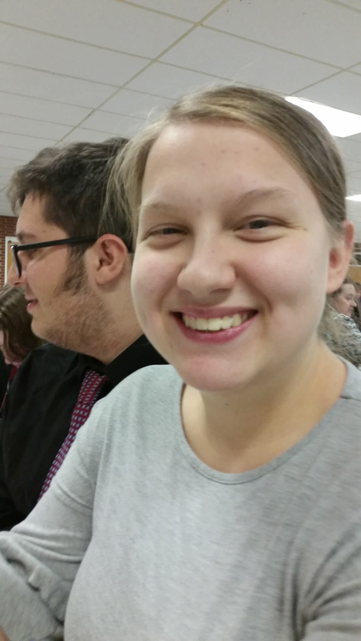 Jennifer smiling at a family dinner, David beside her