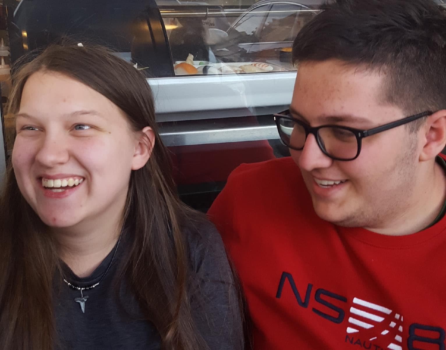 David laughing with a friend at a sushi restaurant
