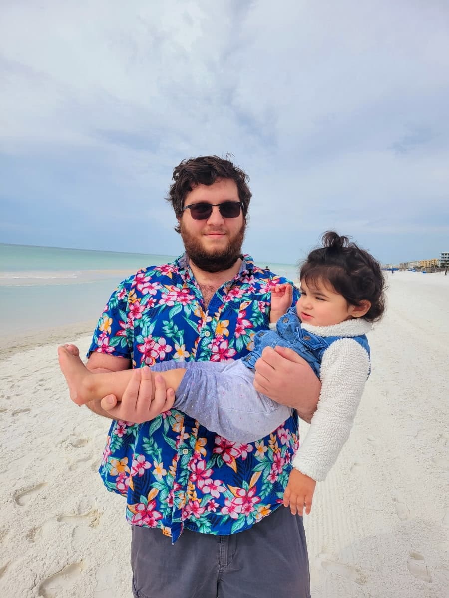David holding a little one on the beach