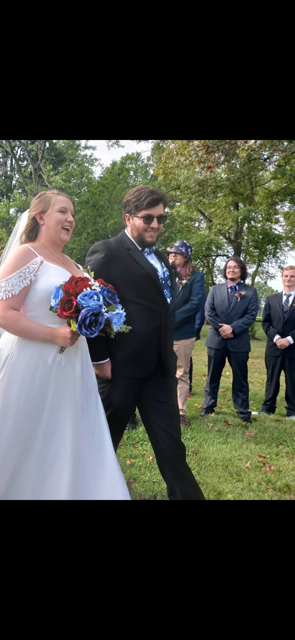 David and Jennifer at their wedding, walking with their wedding party