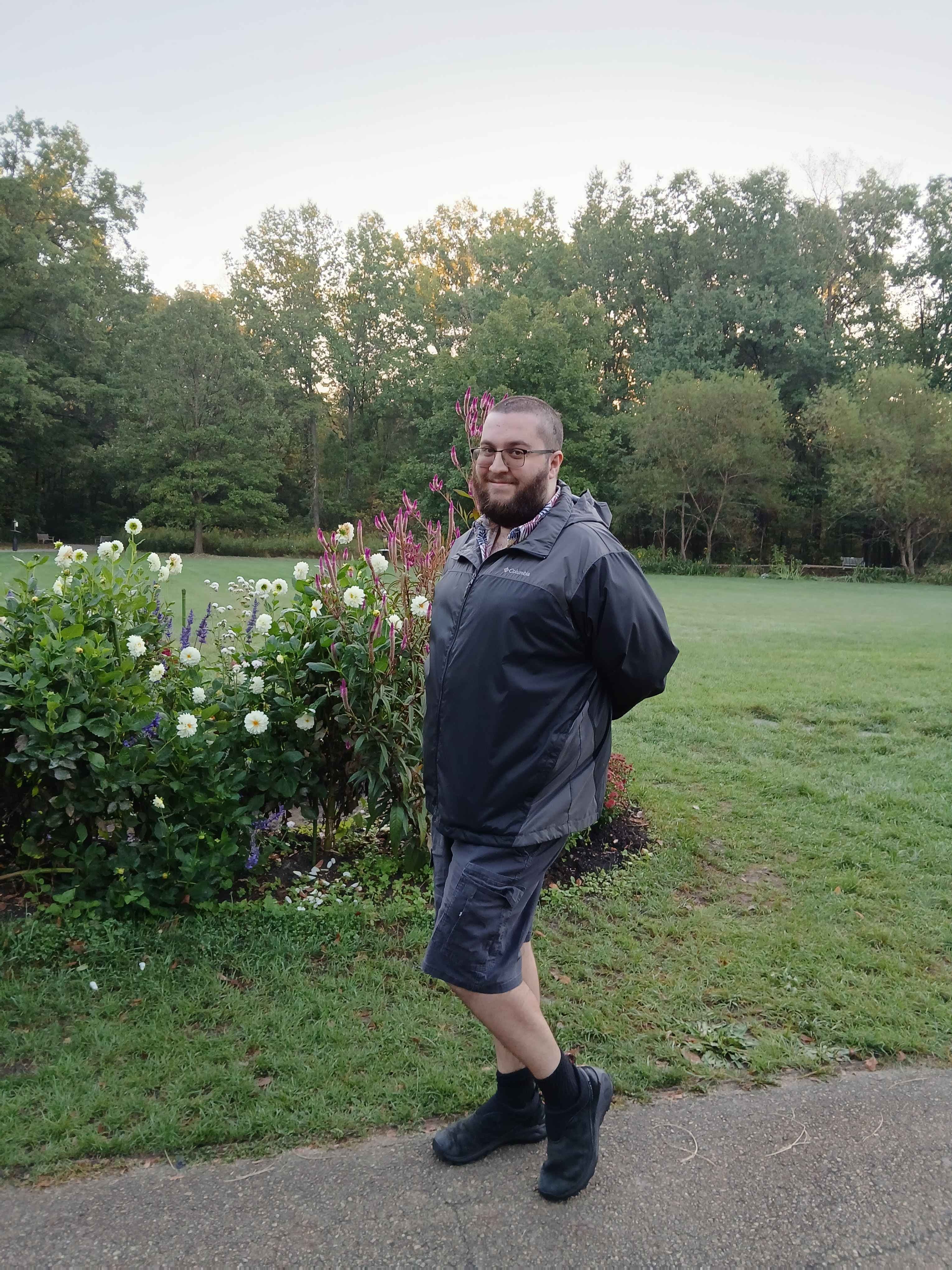 David walking past a flower garden